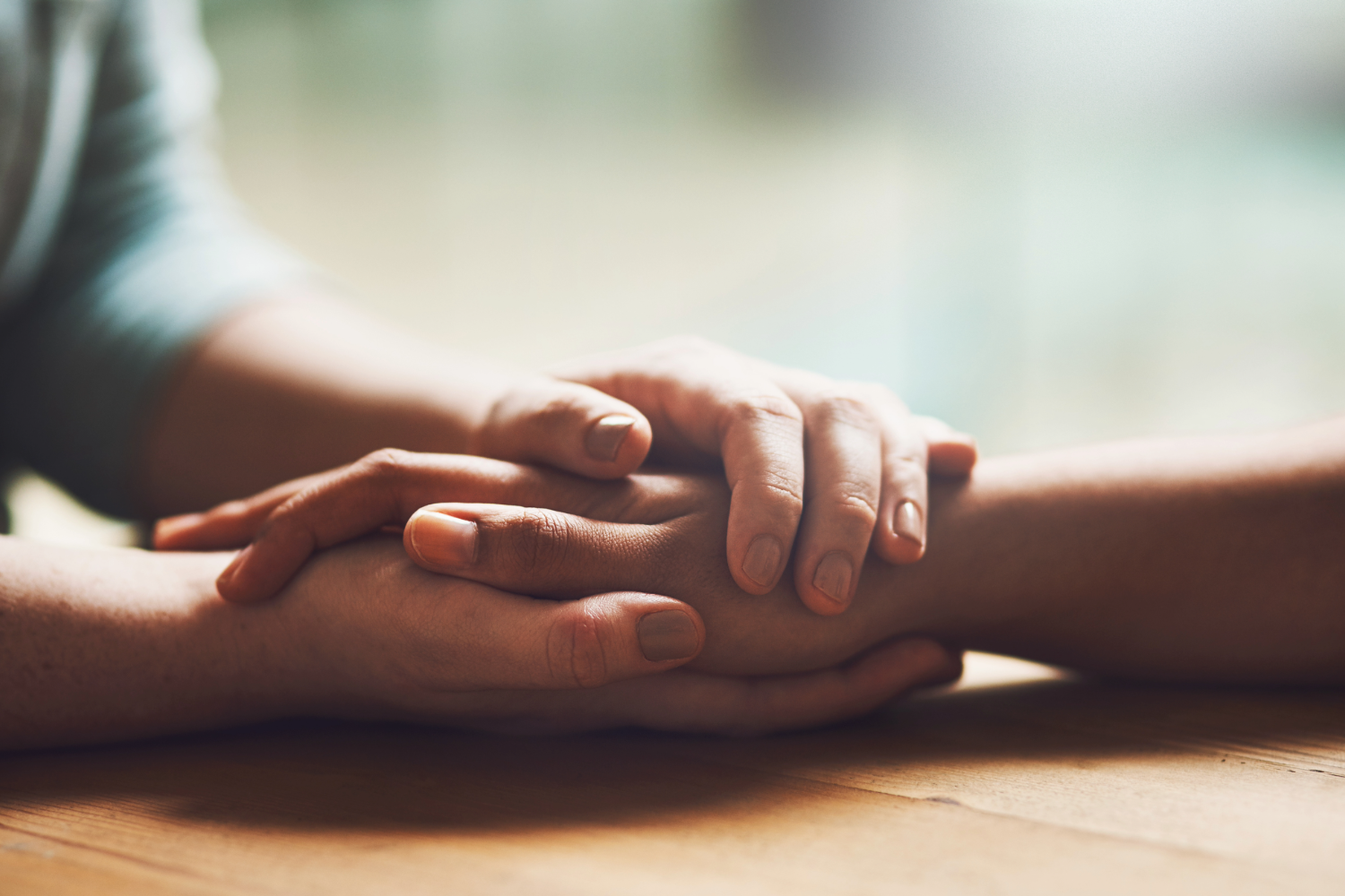 Hands offering comforting support