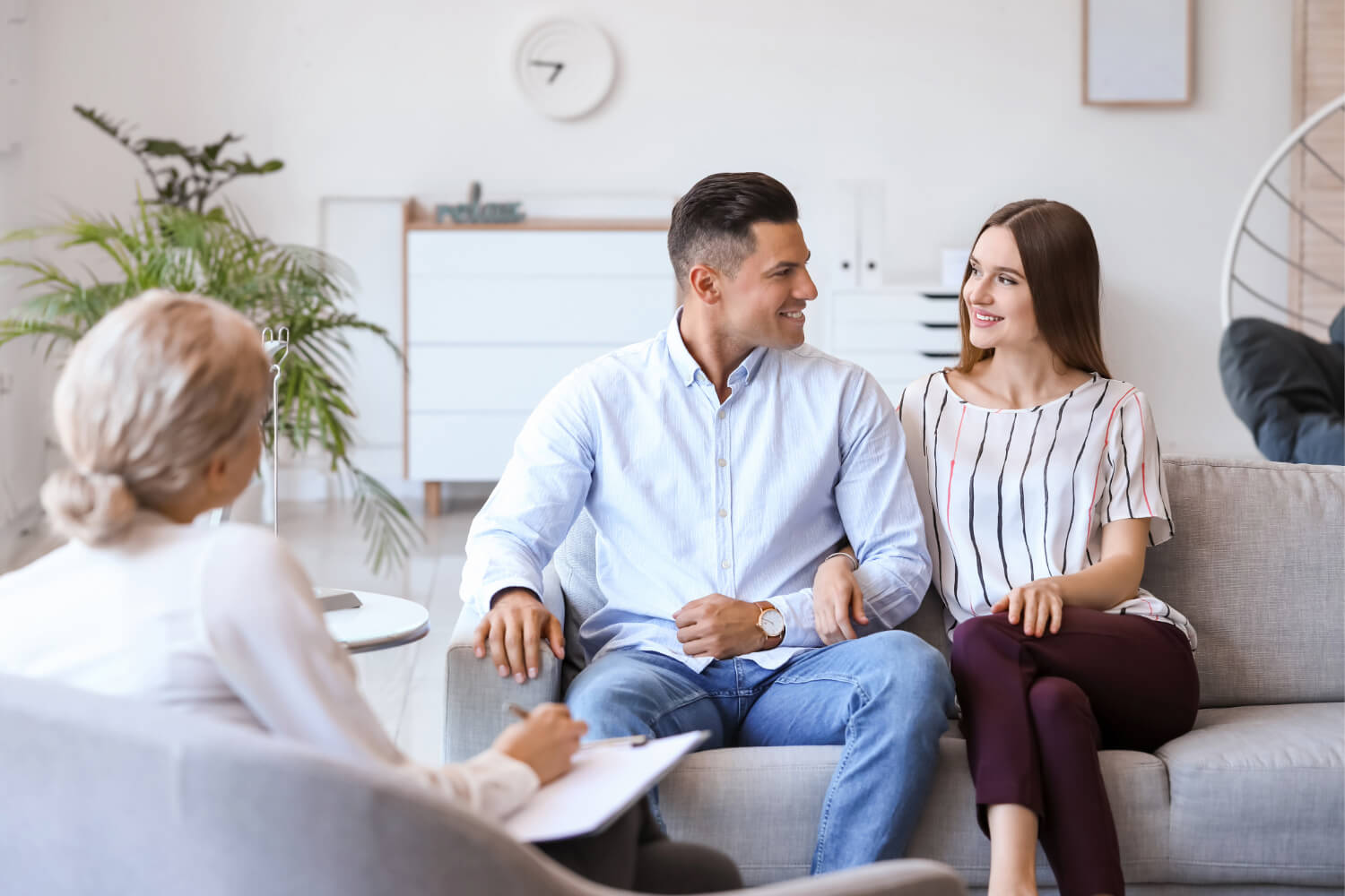 Couple in therapy session, smiling.
