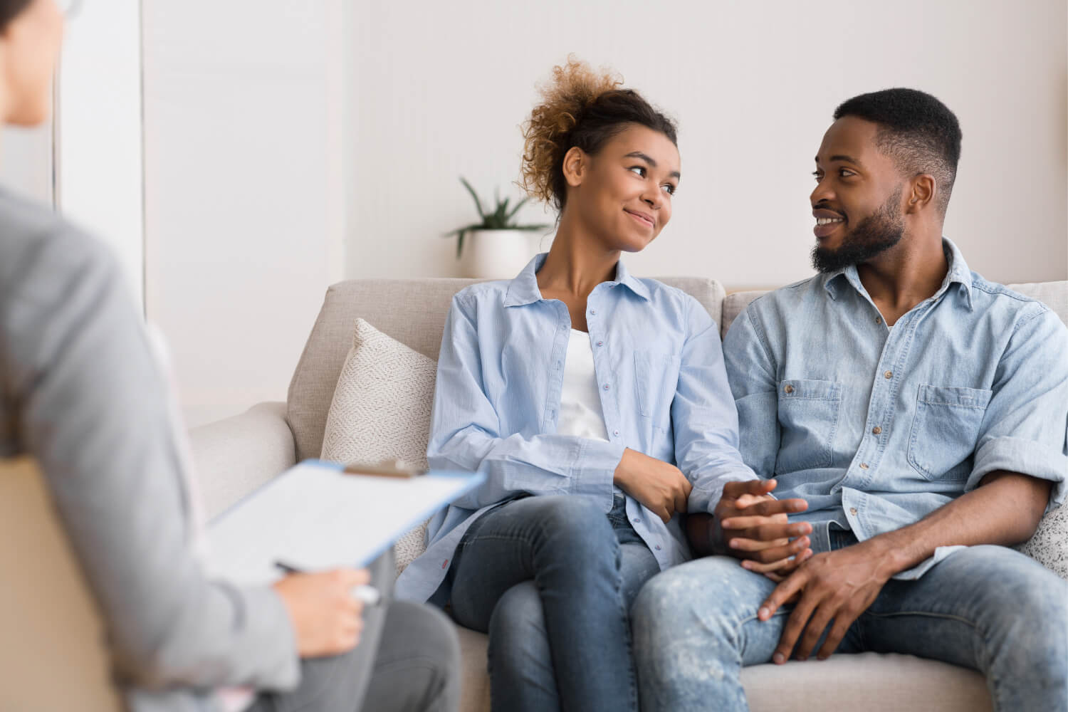 Couple smiling during a therapy session.