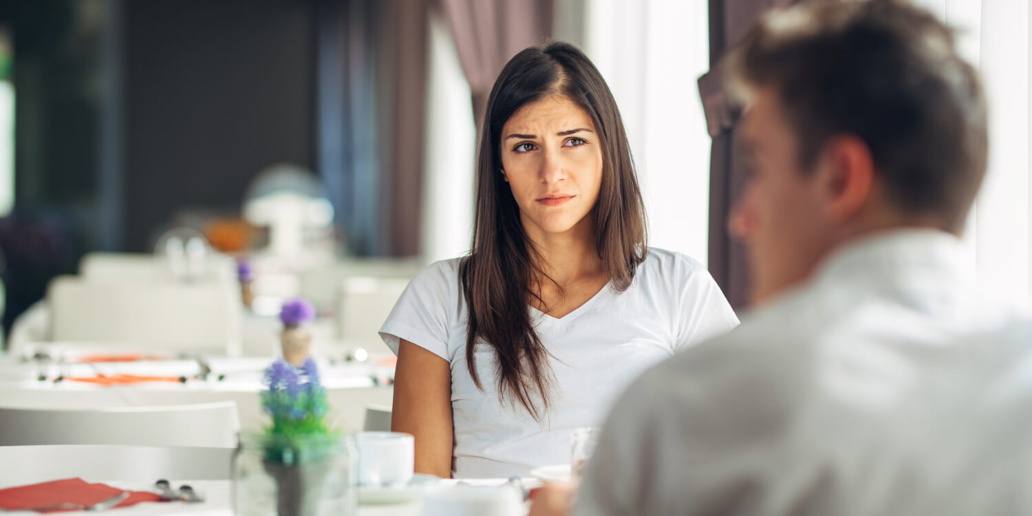 Woman listening to man in discussion.