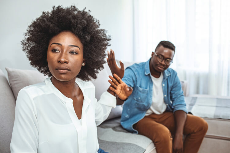 Woman ignoring man in background.