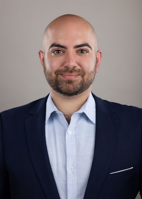 Nicholas Mamey, LMSW, in suit and shirt, smiling.