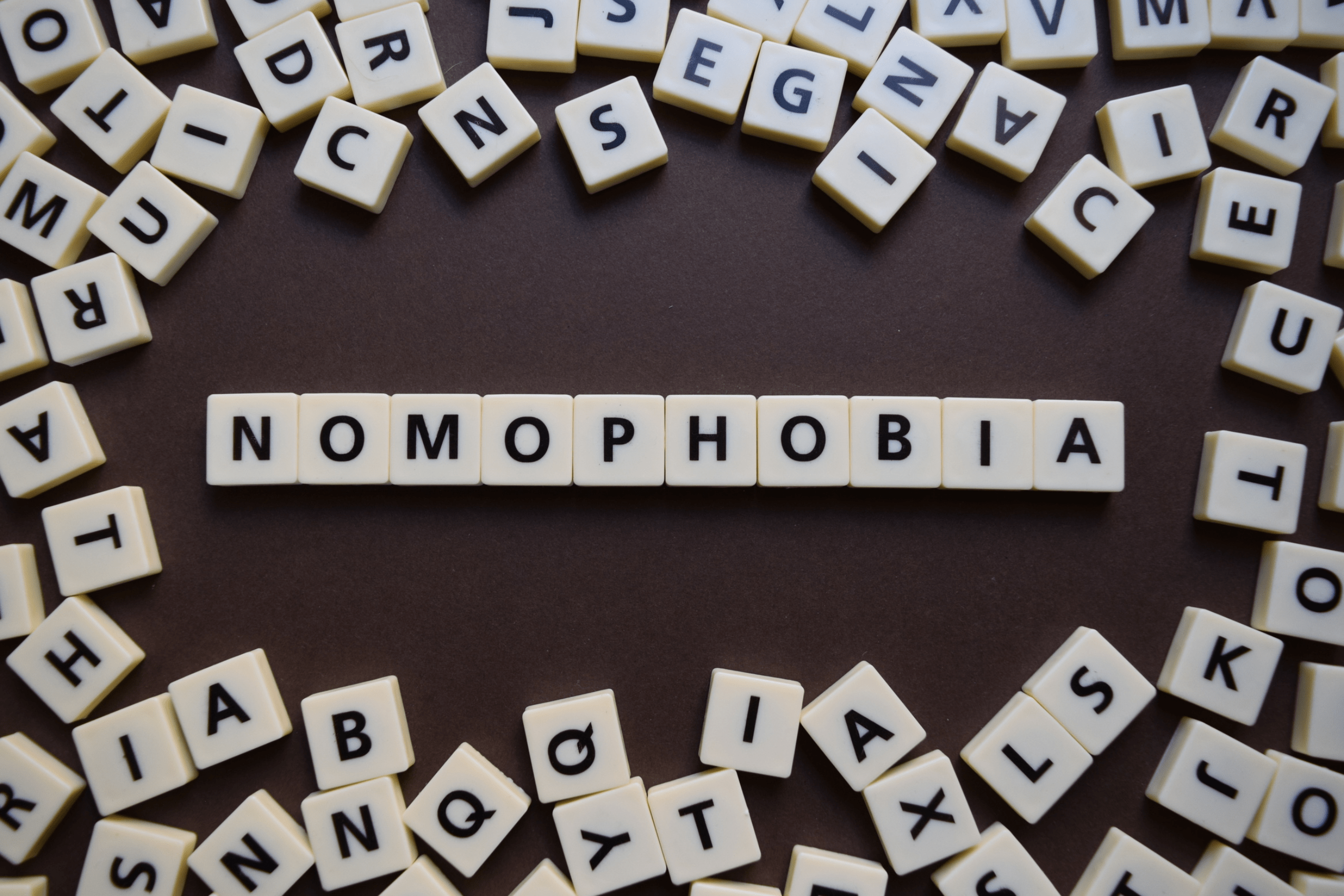 Scrabble tiles spelling "NOMOPHOBIA"