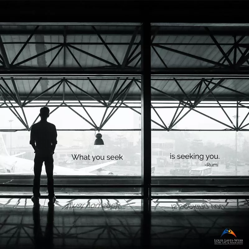 Man standing at airport window with Rumi quote.