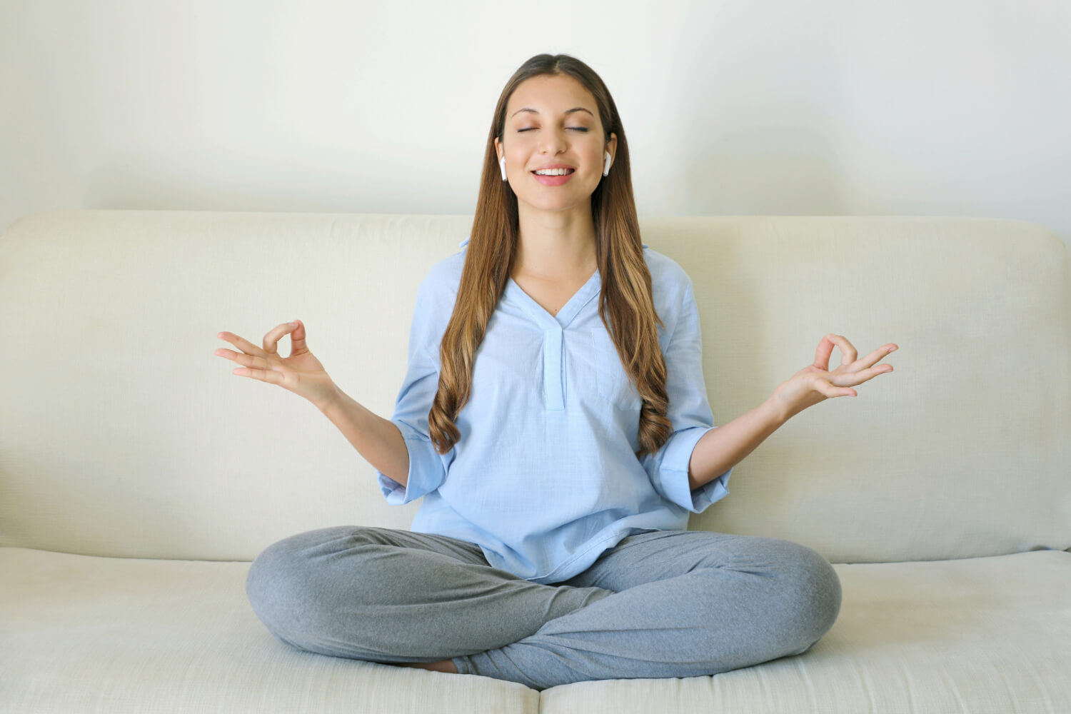 Woman meditating on a couch