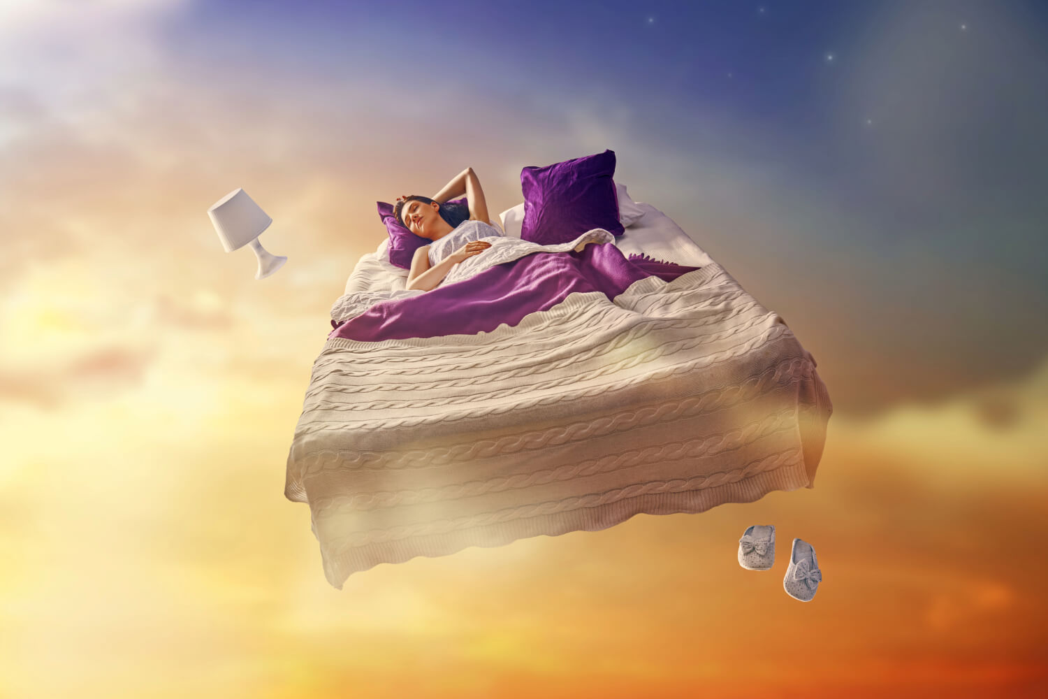 Person sleeping in floating bed amidst sky