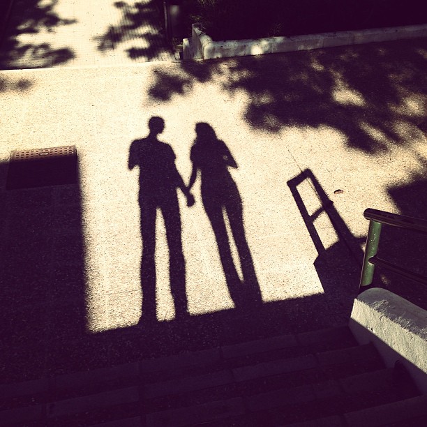 Shadow of a couple holding hands.