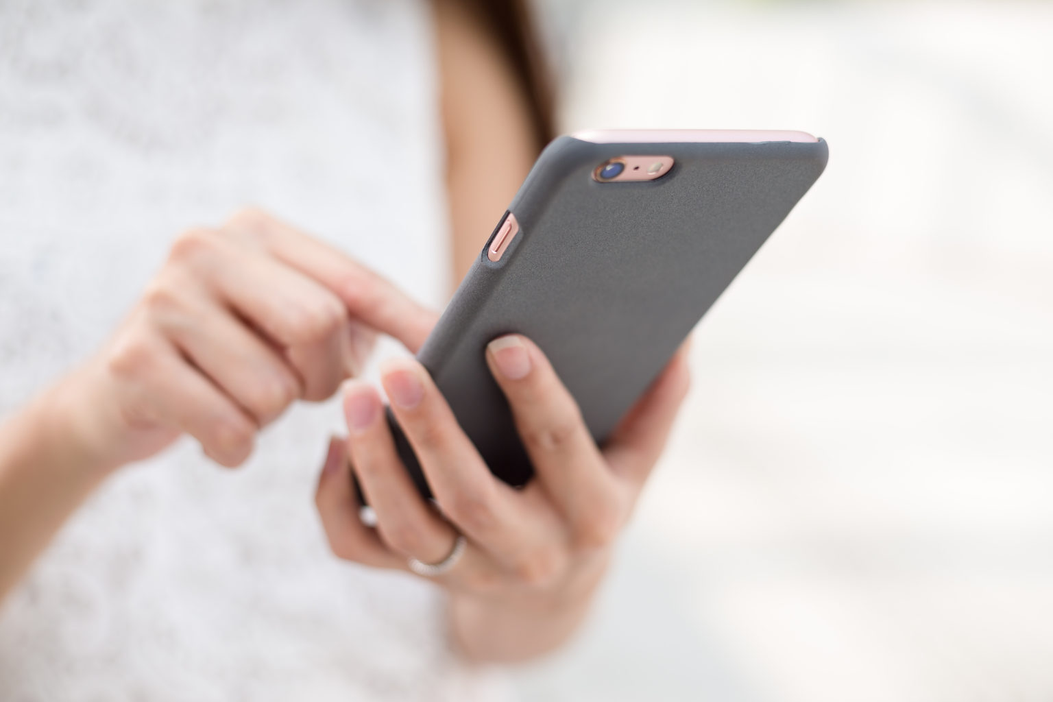 Close-up of a person typing on a smartphone
