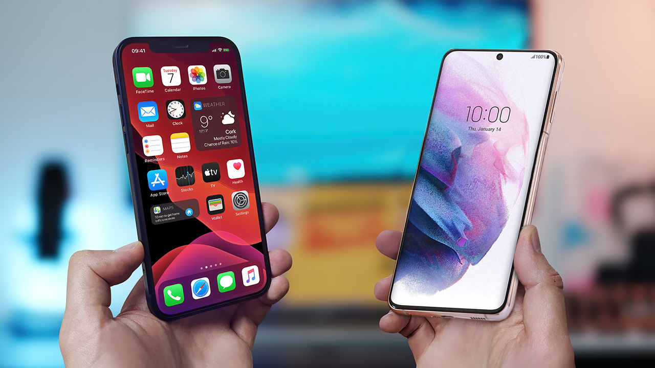Hands holding an iPhone and a Samsung Galaxy phone side by side