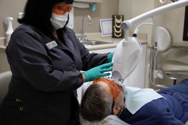 PLACEHOLDER: Relaxed patient in the treatment chair with a team member