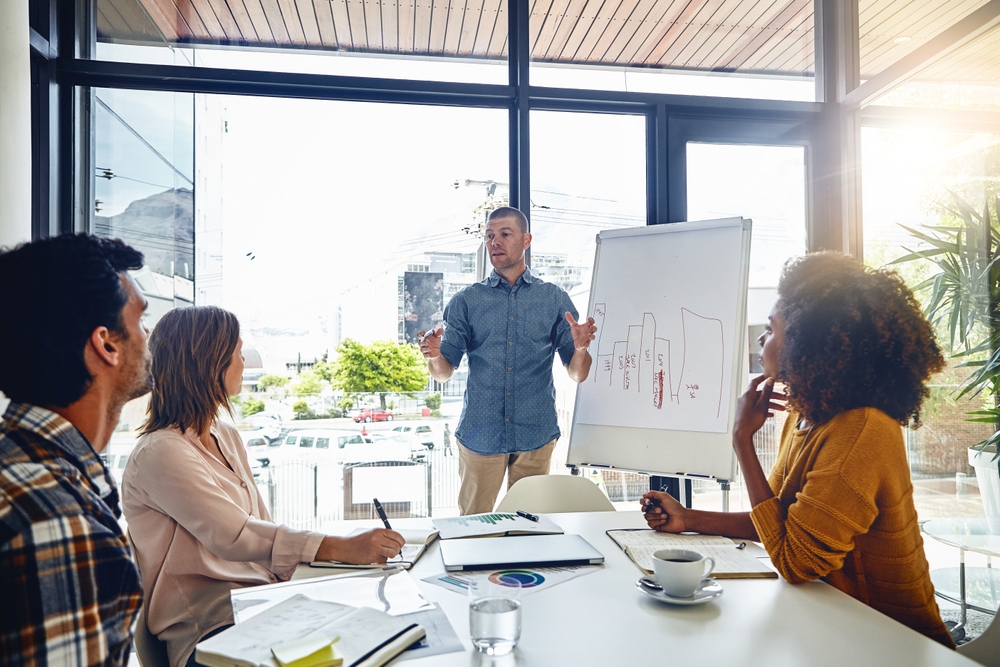 people in a presentation with a flipchart