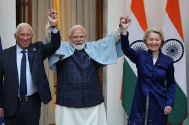 European and Indian leaders raise their arms to show they have sealed the deal