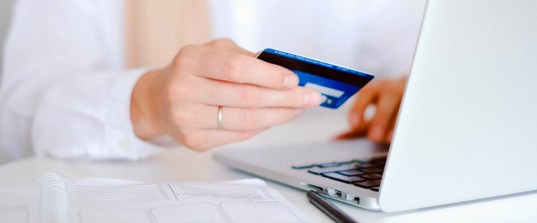 Woman uses credit card from mobile banking app to make online purchase
