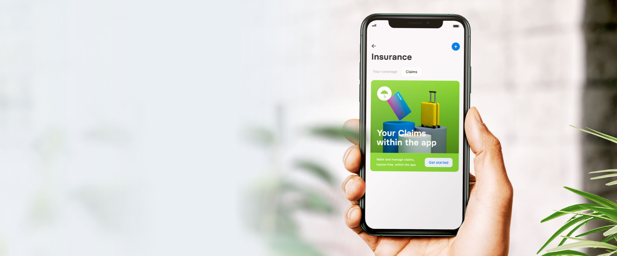 Hand holding mobile phone showing Revolut insurance