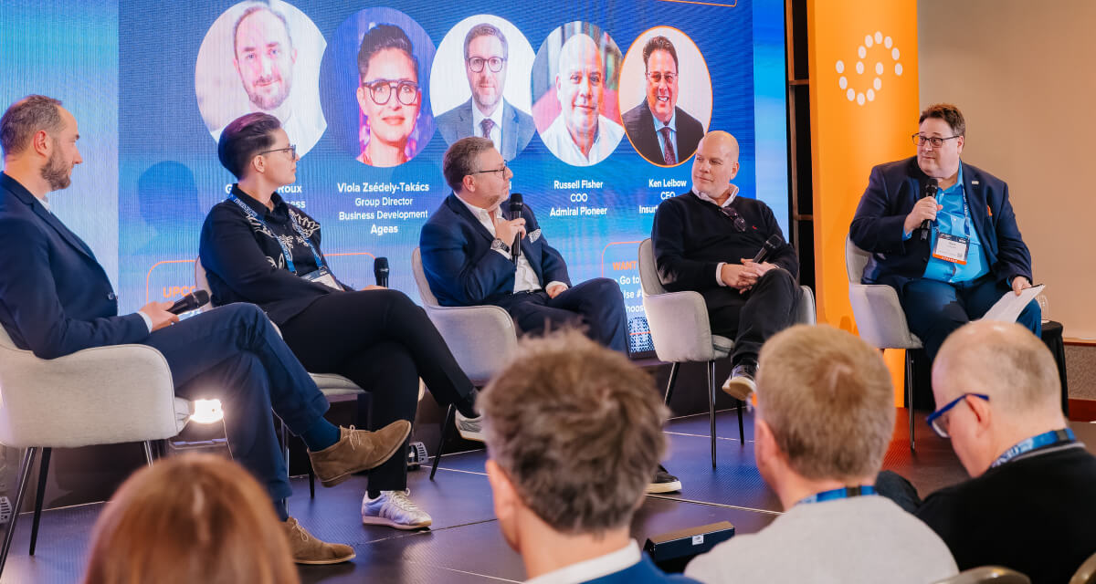Five panelists on stage at Insurtech Insights 2026 taking about frictionless insurance and embedded coverage