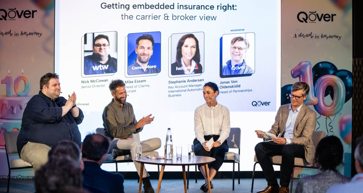 Nick McCowan of WTW, Mike Essam of Cover-More and Stephanie Andersen of Helvetia on stage at Qover's embedded insurance carrier and broker panel, moderated by Jonas Von Oldenskiöld