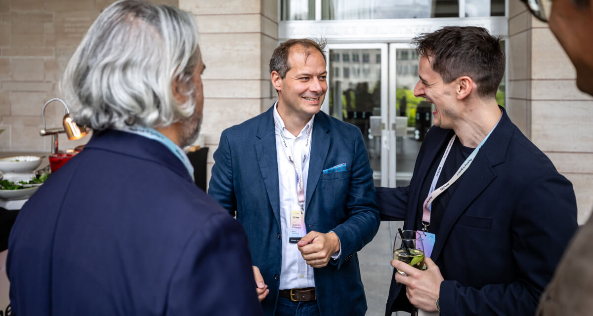 Qover CEO Quentin Colmant networking with partners at Qover's 10-year anniversary summit in Brussels
