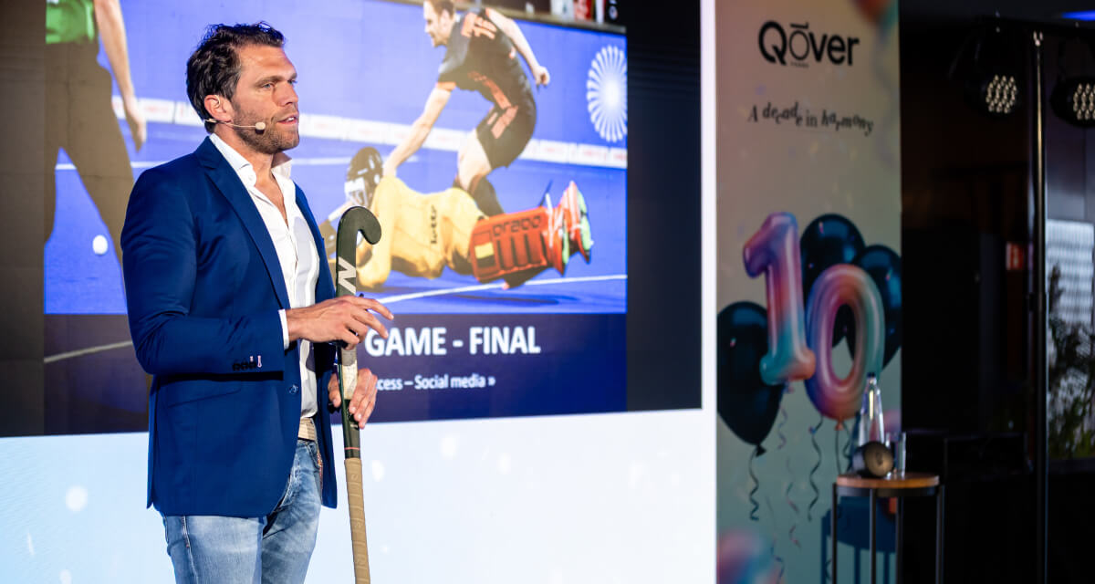 Olympic Gold medallist and field hockey goalkeeper Vincent Vanasch speaking on stage at Qover's 10-year summit in Brussels
