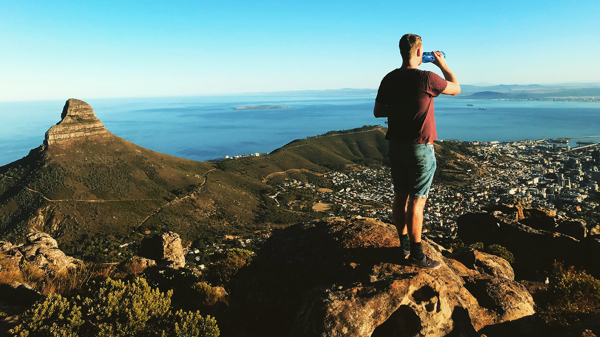 A hiker stops for a breather while taking in the view of Table Bay, Lions Head and the City of Cape Town, from the India Venster Hikig Trail.