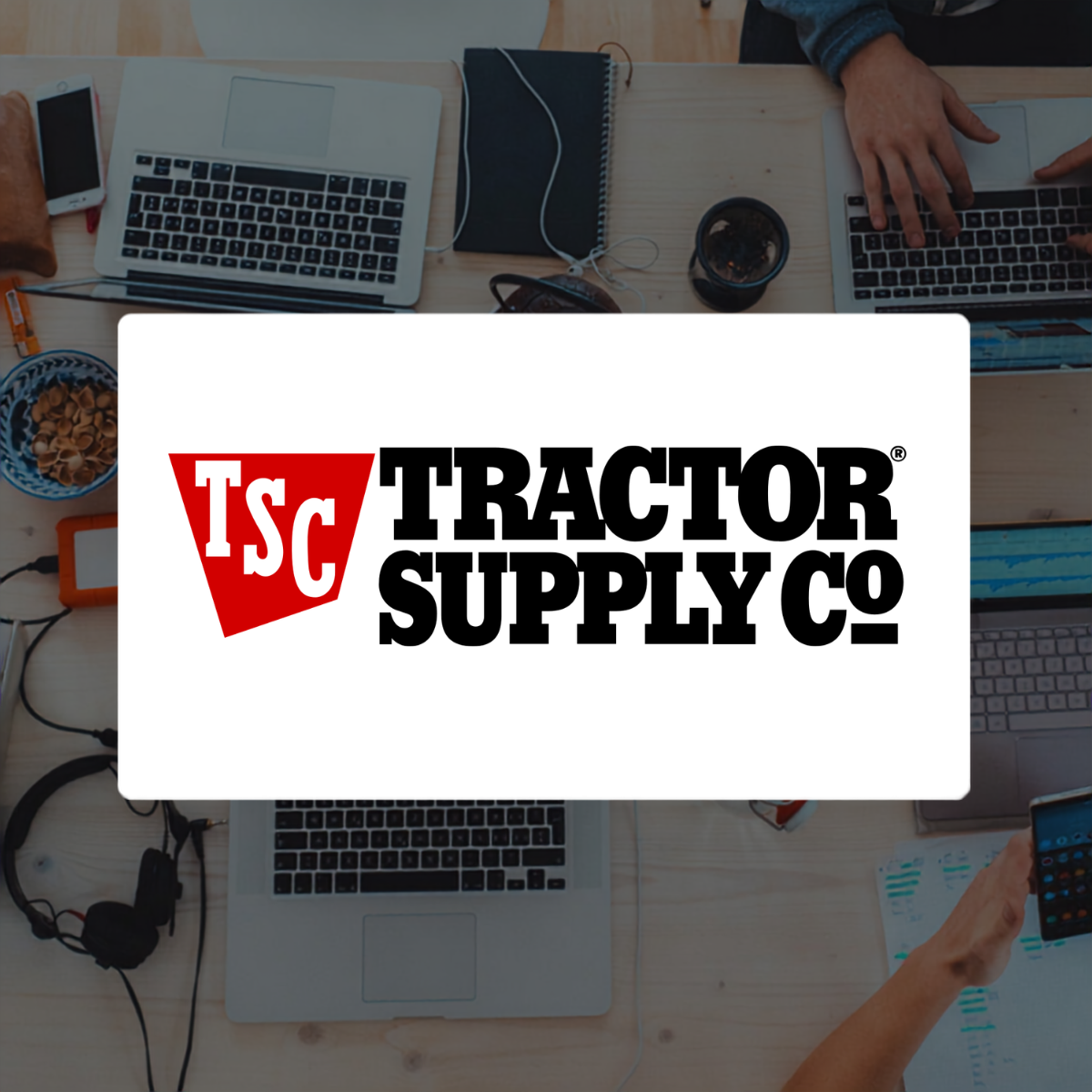 Tractor Supply logo on background with laptops