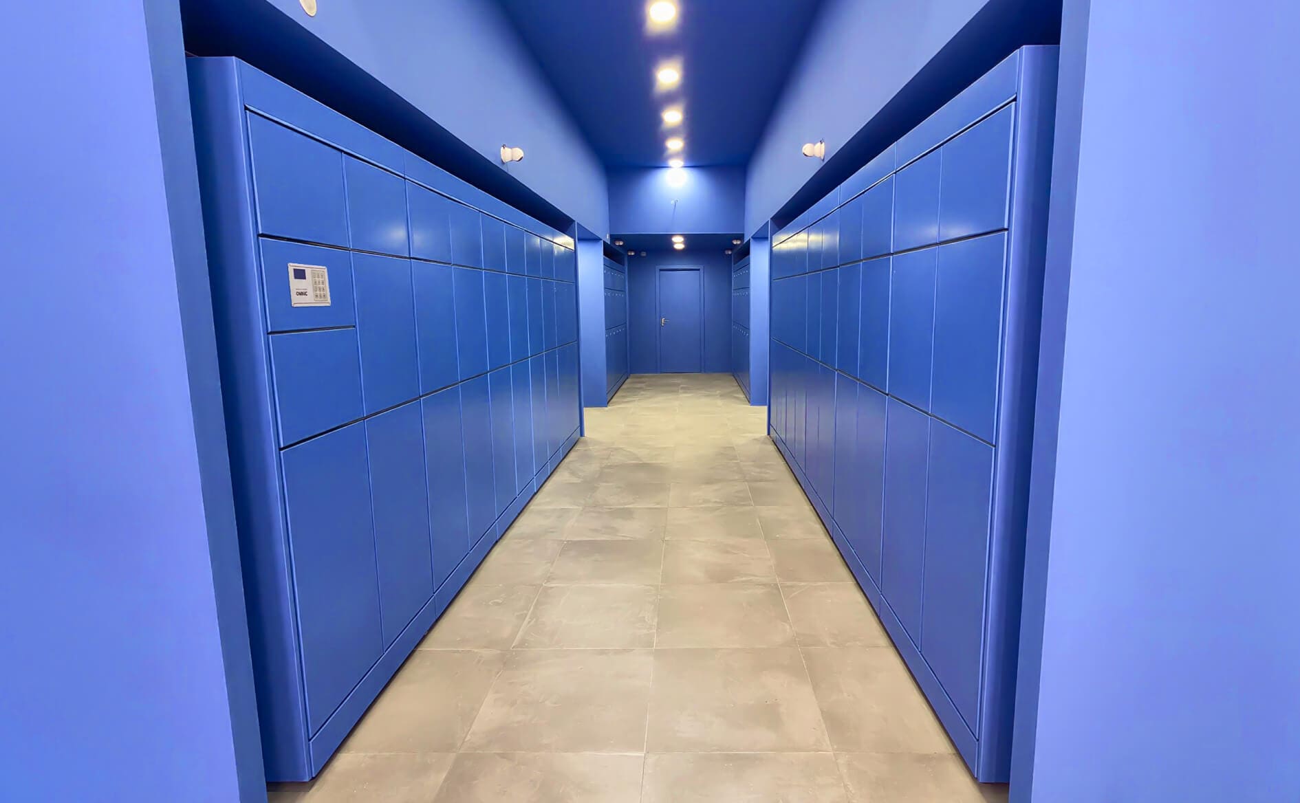 Branded OMNIC luggage lockers installed in a high-traffic travel hub