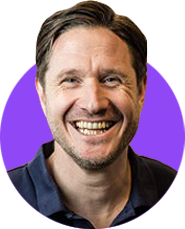 A headshot of a smiling man with short dark brown hair and a dark blue shirt edited within a simple circle graphic that has a bright purple background.