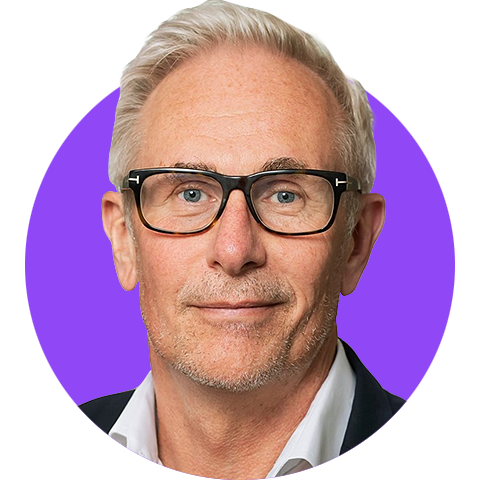 A headshot of a light haired man wearing glasses and a suit edited within a simple circle graphic with a bright purple background.