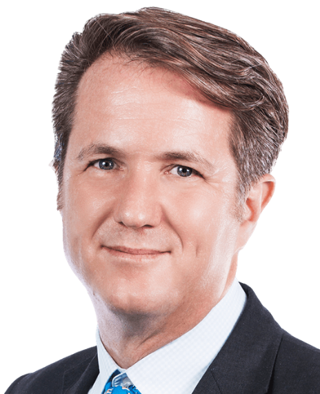 A headshot of a smiling man with short brown hair wearing a suit and tie edited within a simple circle graphic in a bright purple background.