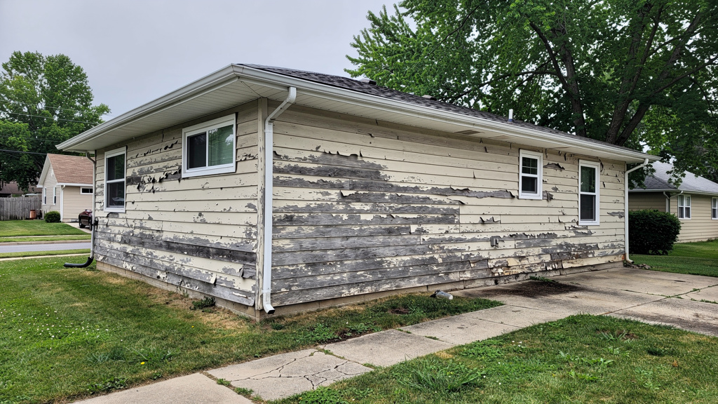 Home exterior with widespread siding damage