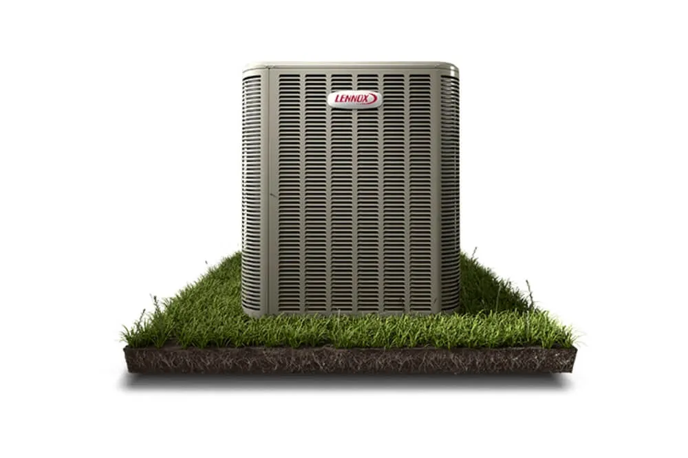 Lennox air conditioning unit placed on a grassy platform, showcasing the unit's exterior design.