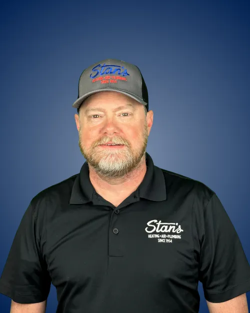 Jason Johnson in Stan's HVAC uniform with cap, blue background.