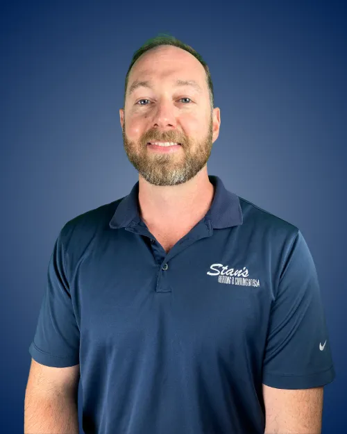 Mike Pell in Stan's HVAC polo shirt against blue background.