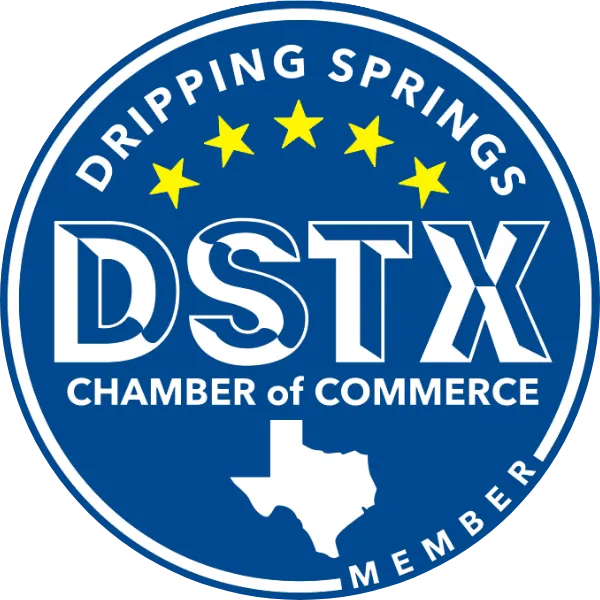 Blue circular logo of Dripping Springs Chamber of Commerce with the acronym DSTX, four yellow stars, and a white silhouette of Texas.