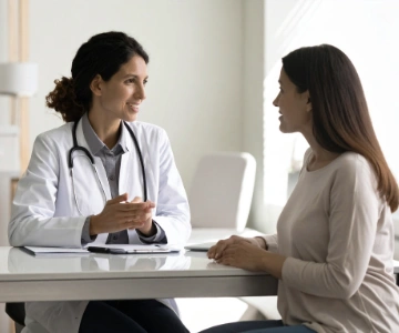 Female primary care physician discussing birth control options with adult patient in exam room in Brentwood medical office.