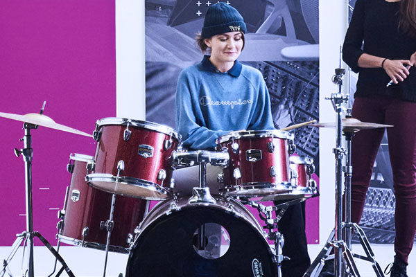 A female student practicing drums