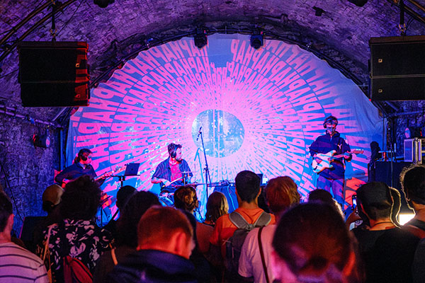 Wide shot of a band performing in front of a crowd