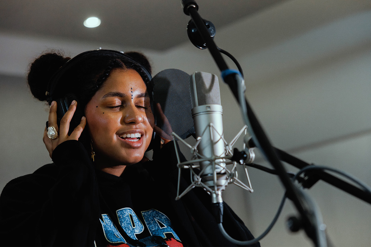 A student recording vocals