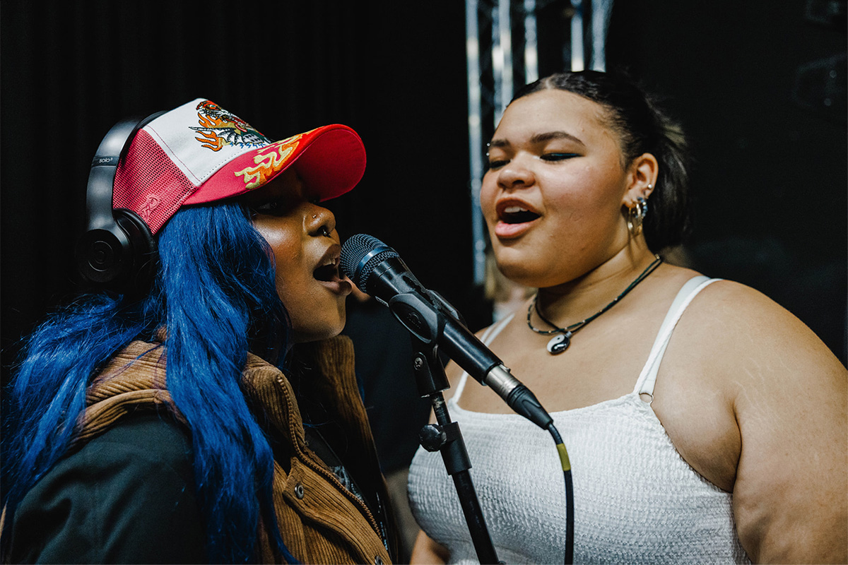 Two students recording vocals