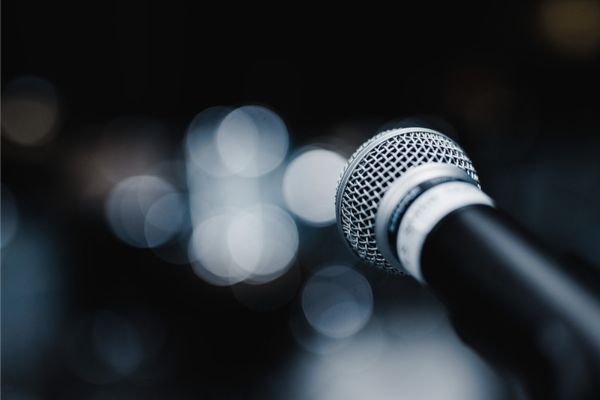 Microphone on stage, pixelated background