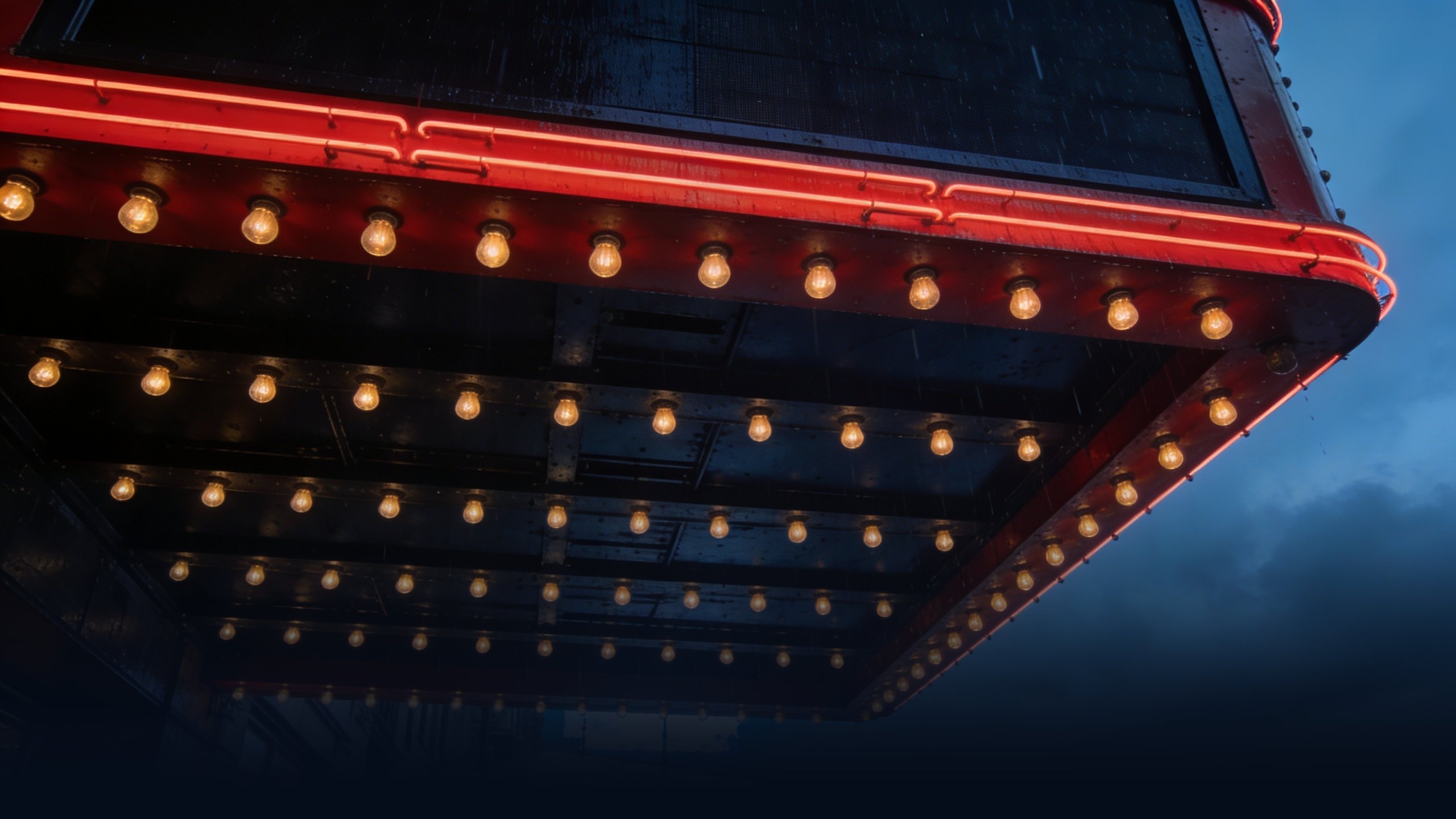 Underside of a classic Manhattan movie theater marquee at twilight — illustrating film distribution in the United States