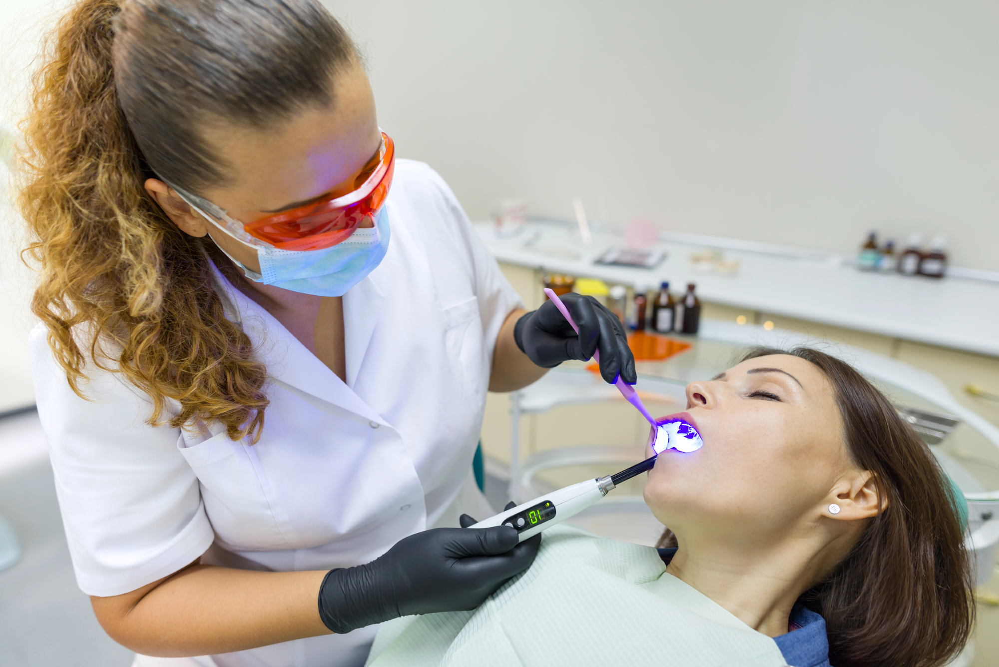woman sleeping and getting oral care at Sedation Dentist Miramar