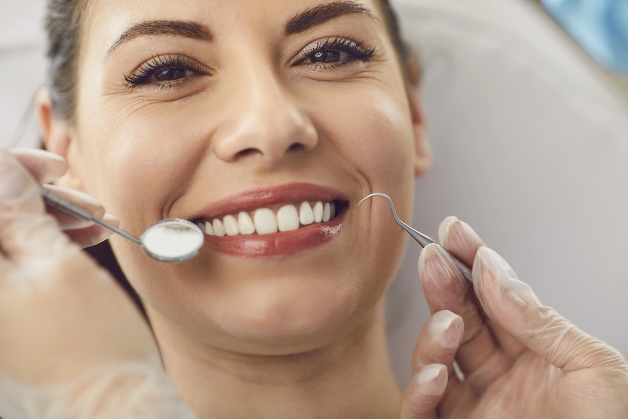 woman smiling during a checkup at the Dentist Miramar FL