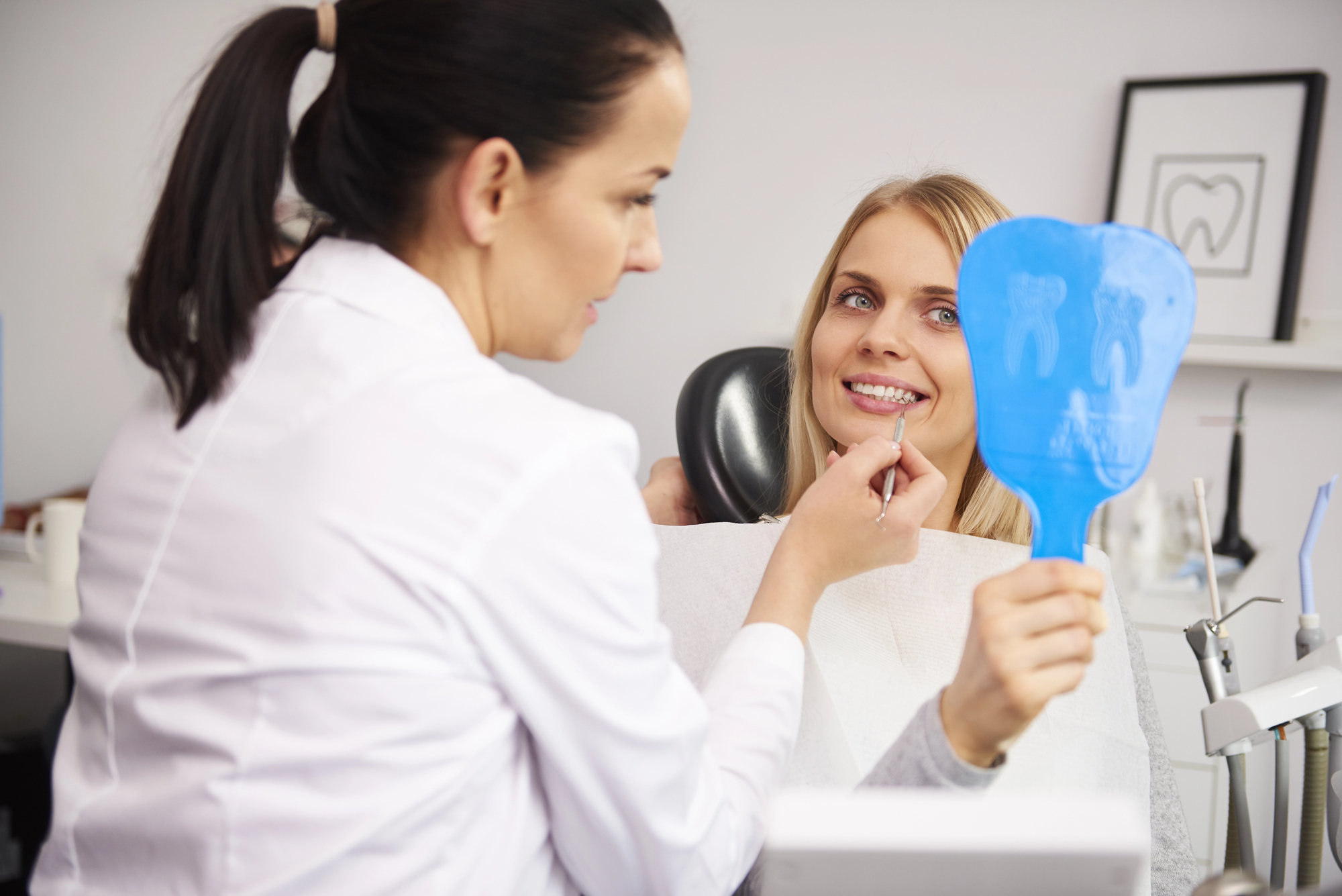 dental patient looking in the mirror at the cosmetic dentist Miramar