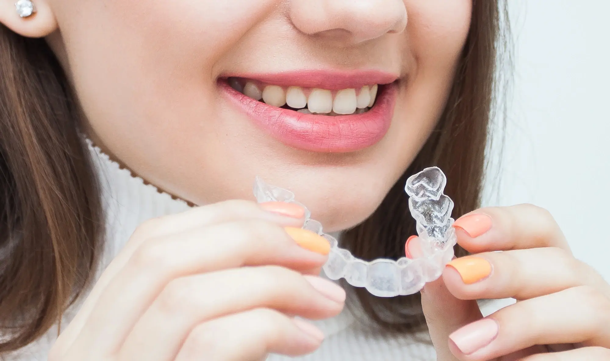 woman holding clear aligner Miramar