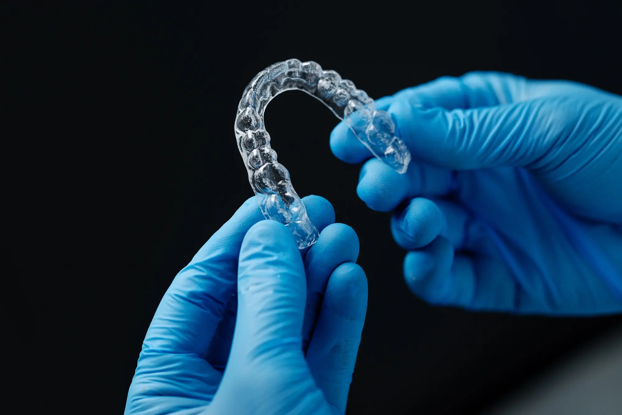 dentist holding clear aligner Miramar