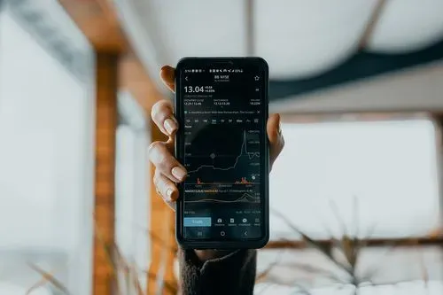 a phone showing stocks and graphs