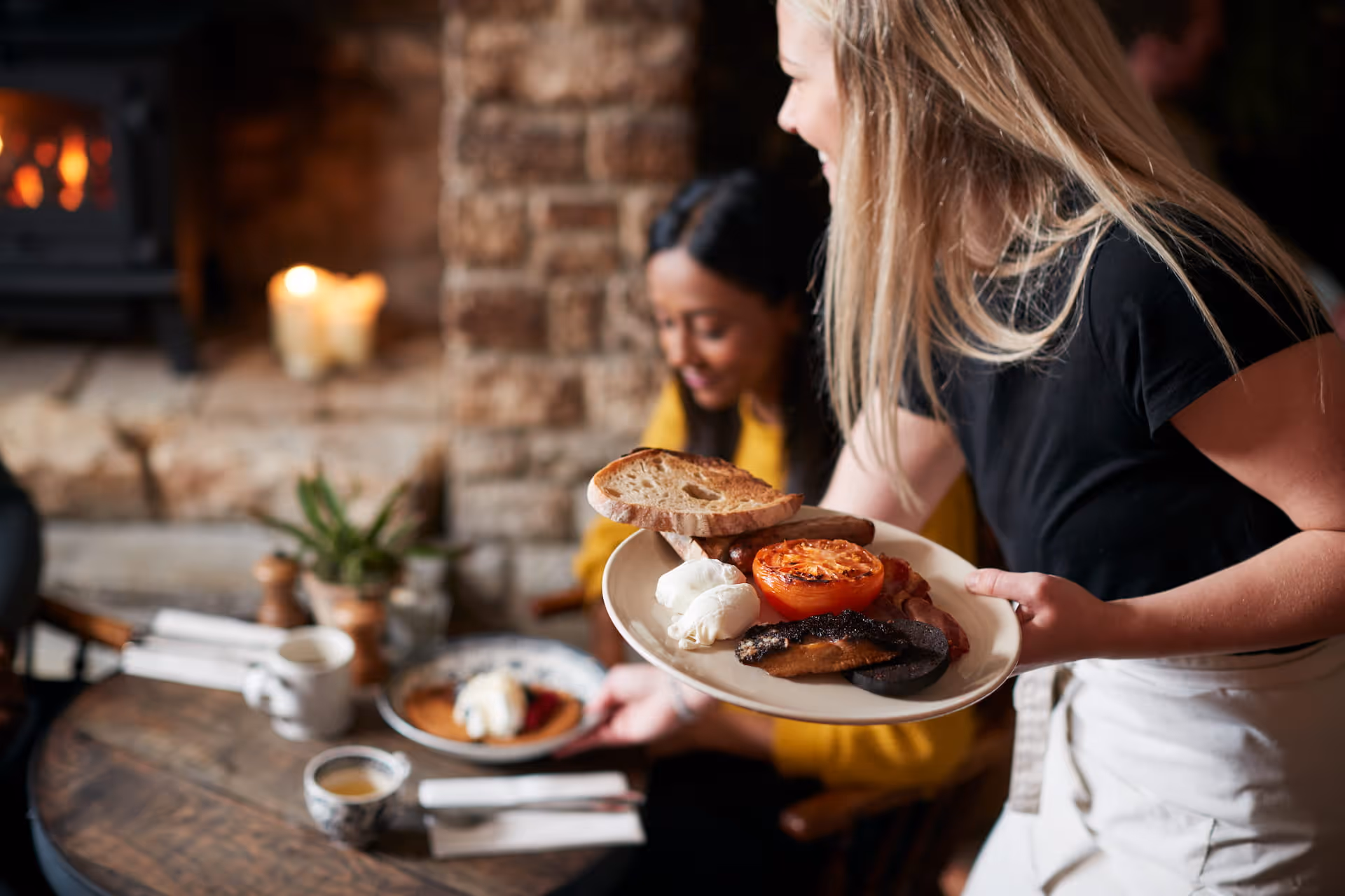 woman serving customer food in restaurant