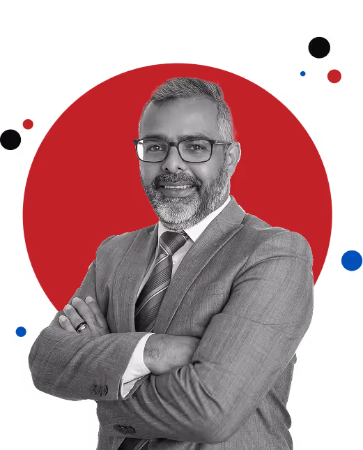 A man in a suit and tie standing with his arms crossed.