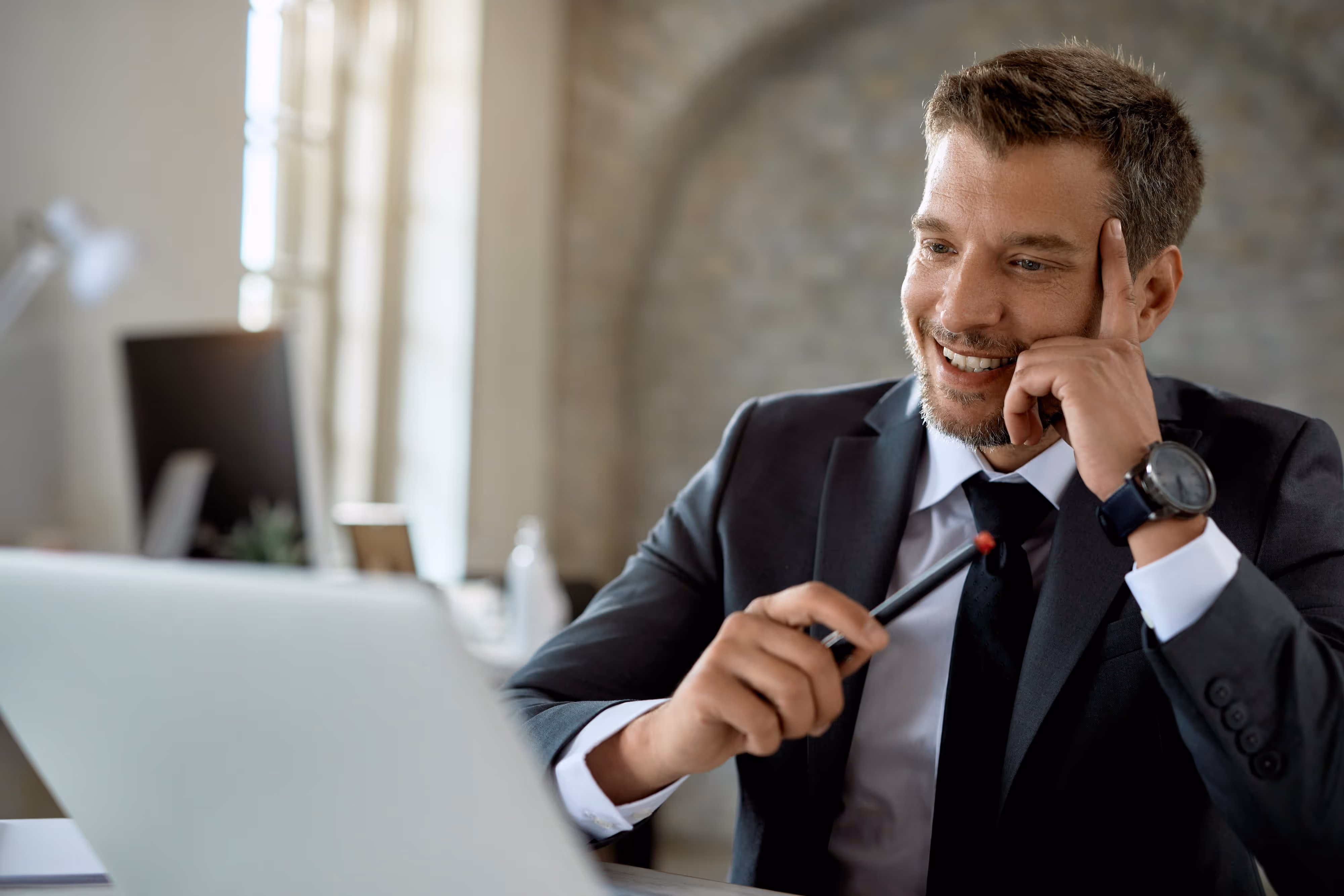 happy mid adult businessman working computer reading email office