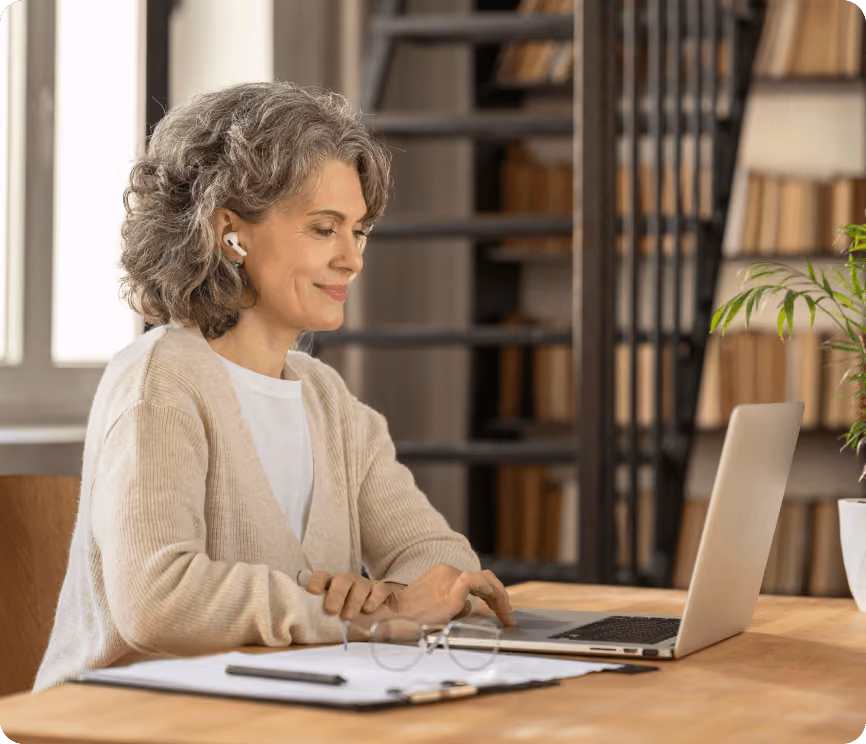 A woman working at a laptop computer.